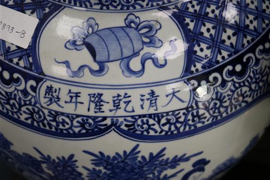 A massive Chinese blue and white vase and wood stand